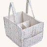 A soft light blue Avery Row nappy caddy organiser with a nature design on a cream background.