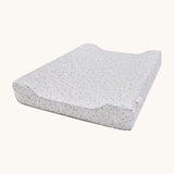A light blue Avery Row changing pillow with a nature design on a cream background.