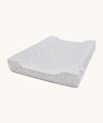 A light blue Avery Row changing pillow with a nature design on a cream background.