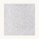 A soft light blue Avery row muslin swaddle with a nature trails design on a cream background
