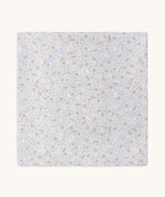 A soft light blue Avery row muslin swaddle with a nature trails design on a cream background