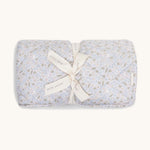A soft light blue coloured Avery Row playmat with a nature design on a cream background.