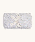 A soft light blue coloured Avery Row playmat with a nature design on a cream background.