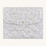 A soft light blue coloured Avery Row travel changing mat with a nature design on a cream background.