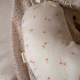 A close up of the print on a an Avery Row Nursing Pillow with an Anemone design. The The top of the pillow features a white background with a delicate pink anemone flower print. Avery Row have a range of baby and nursery products with stylish designs available at Babipur. 