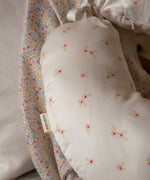 A close up of the print on a an Avery Row Nursing Pillow with an Anemone design. The The top of the pillow features a white background with a delicate pink anemone flower print. Avery Row have a range of baby and nursery products with stylish designs available at Babipur. 