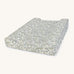 A soft Avery Row changing cushion with a flower design on a cream background.