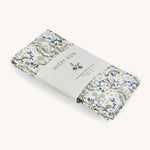 A soft Avery Row changing cushion cover with a flower design on a cream background.