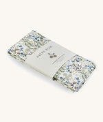 A soft Avery Row changing cushion cover with a flower design on a cream background.