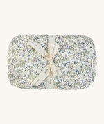 A soft Avery Row playmat with a flower design on a cream bakground.