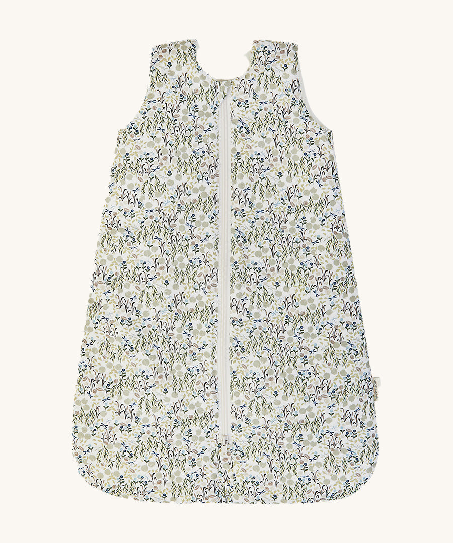 A Avery row baby sleeping bag with a flower design on the front on a cream background.