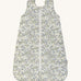 A Avery row baby sleeping bag with a flower design on the front on a cream background.