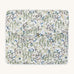 A soft Avery Row travel changing mat with a flower design  on a cream background.