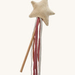 A soft beige Avery row star on a wooden stick and soft fabric strands on a cream background.