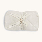 A soft light coloured Avery Row playmat with a wild chamomile design on a cream background.