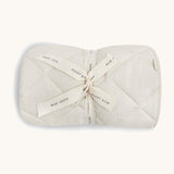 A soft light coloured Avery Row playmat with a wild chamomile design on a cream background.