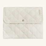A soft light coloured Avery Row trael mat with a wild chamomile design on a cream background.