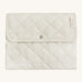 A soft light coloured Avery Row trael mat with a wild chamomile design on a cream background.