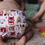 Baba + Boo Transport Nappy worn by baby with toys on the floor