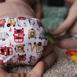 Baba + Boo Transport Nappy worn by baby with toys on the floor