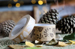 Close up of the Babipur kraft eco paper tapes in the Autumn leaves prints next to some pinecones