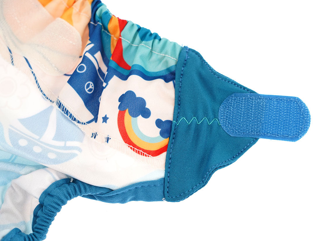 The velcro straps on The Close Pop-In x Babipur exclusive reusable nappy wrap, in a Babipur World print