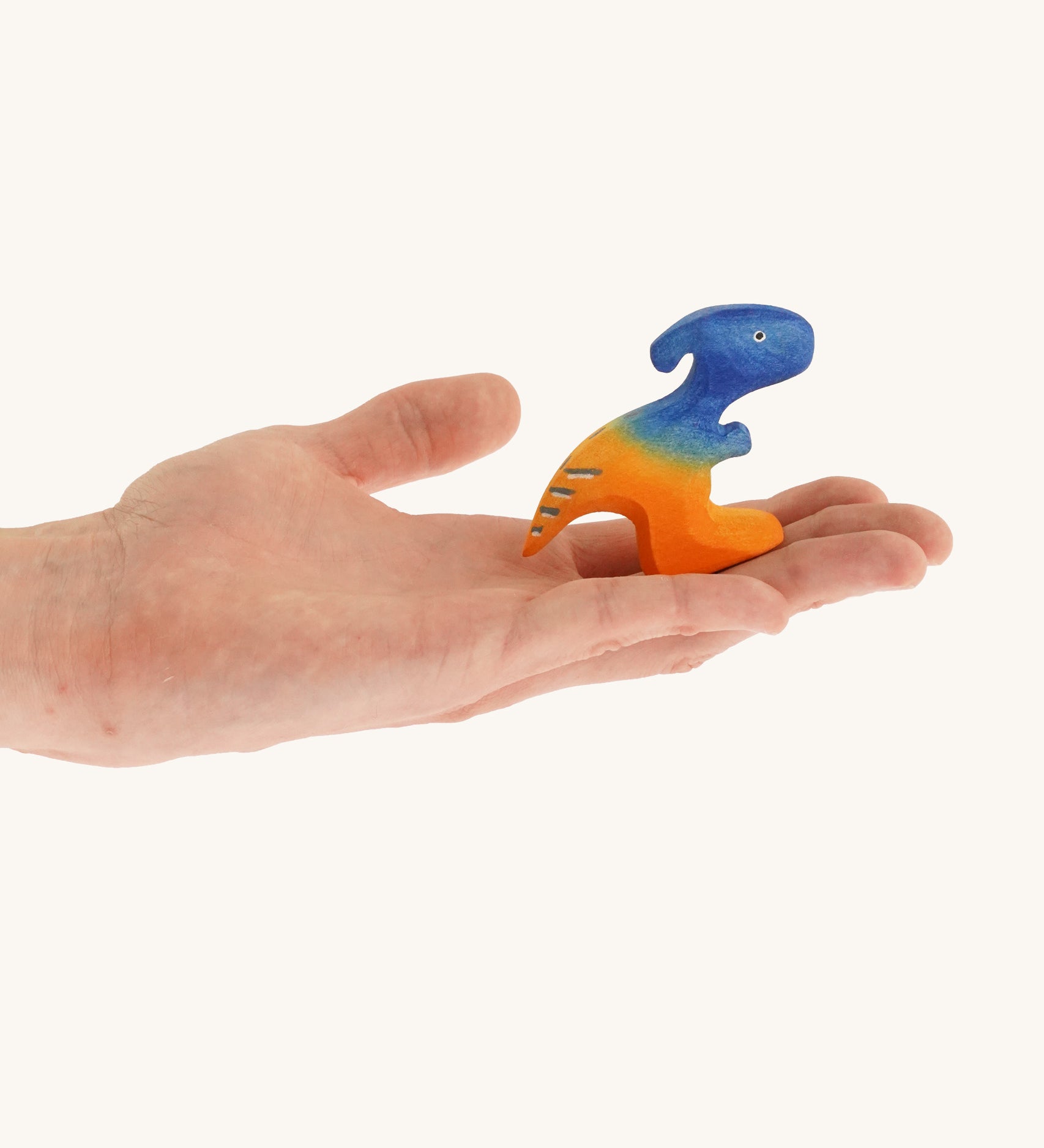 Blue and orange standing baby Parasaurolophus on a hand