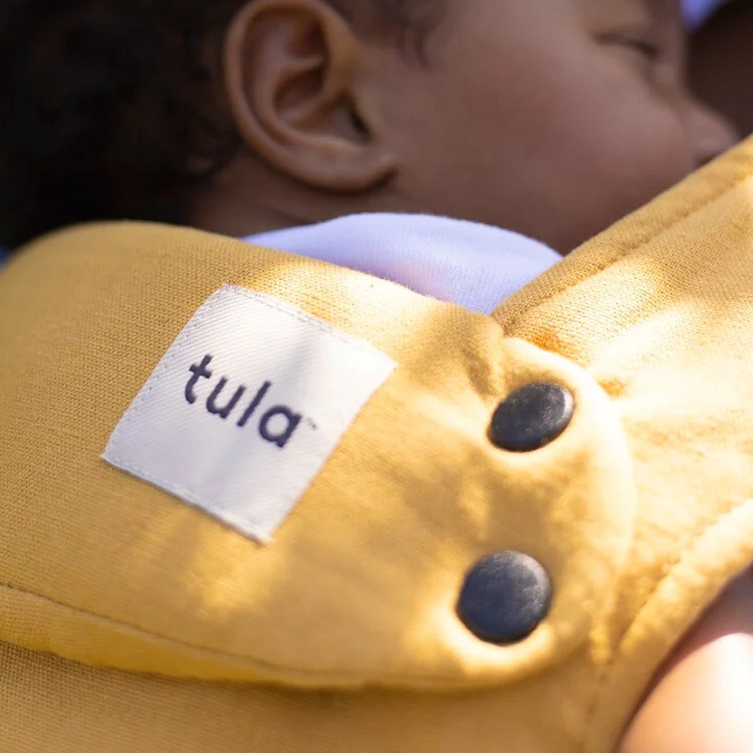 Tula - Hemp Explore Baby Carrier - Citrine. Here we see the material detail and garment branding.