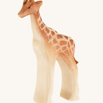 Baby wooden standing Giraffe on a cream background