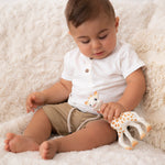  smiling giraffe teether on a cream background