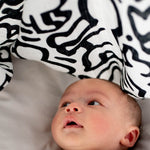  and looking up at the The Etta Loves X Keith Haring Extra Large Organic Cotton Baby Muslin Square - Baby