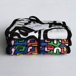 A child look at the 'Brazil' print on the Etta Loves X Keith Haring Reversible Baby Sensory Strip