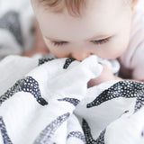 A child grasping the XL Starfish muslin cloth 