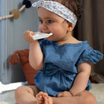 A child on a light grey sofa