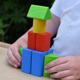 Child playing with the blocks from the Bajo 10 piece sorting board. 