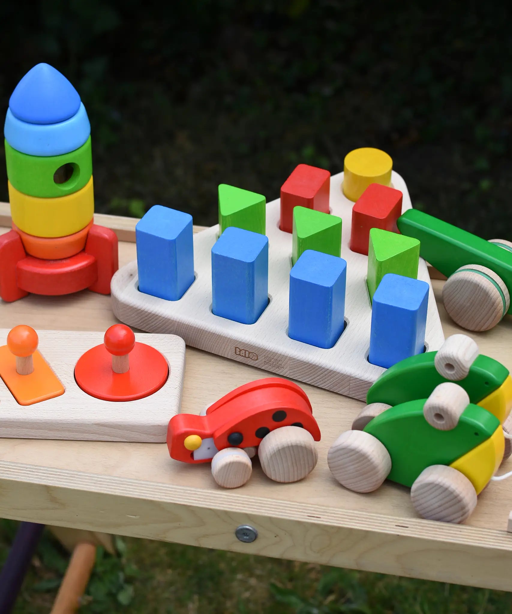 Bajo 10 piece sorting board placed on a Miri slide surrounded by other Bajo wooden toys.