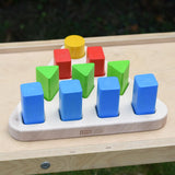 Bajo 10 piece sorting board. Wooden triangle base with 10 slots, 4 square, 3 triangle, 2 rectangle and 1 circle with 10 blocks to fit inside. 