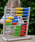 Child playing with the Bajo 100 Bead Abacus counting toy. 