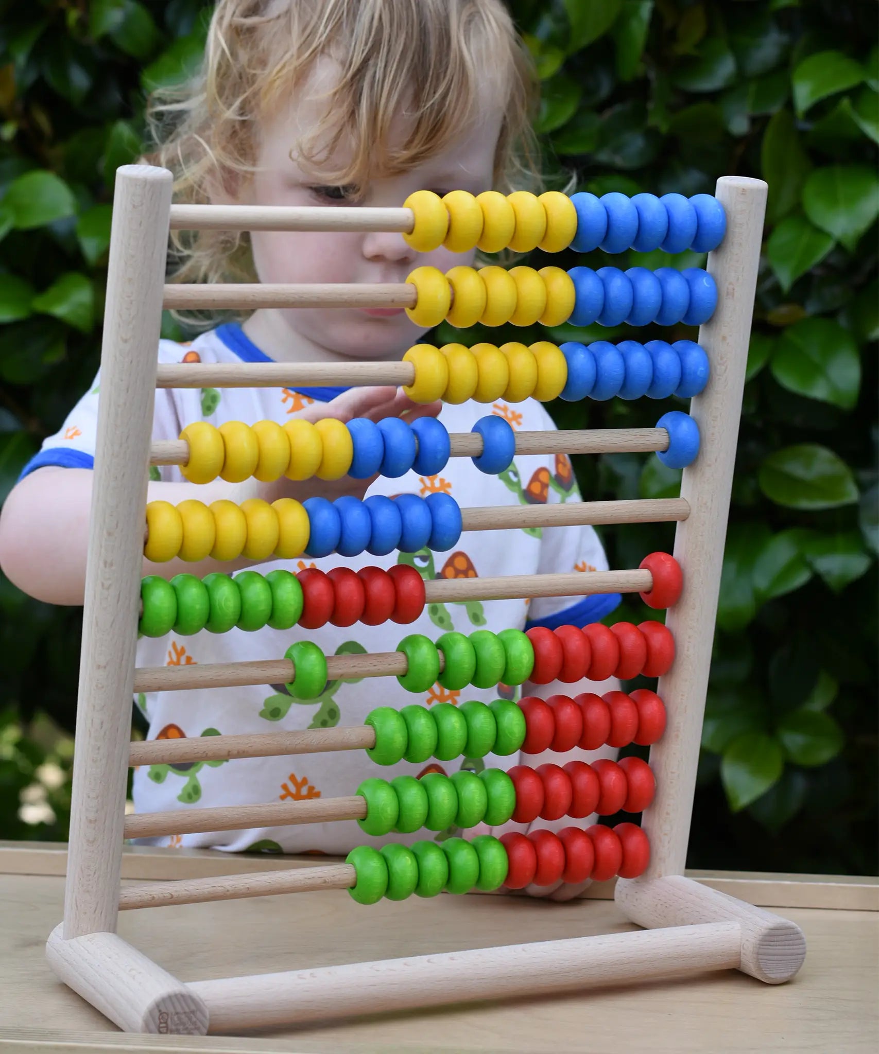 Child playing with the Bajo 100 Bead Abacus counting toy. 