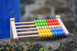 Bajo 50 bead wide abacus placed on a stone wall.