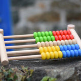 Bajo 50 bead wide abacus placed on a stone wall.