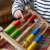 Close up of a child playing with the Bajo 50 bead wide abacus in the Babipur playroom.