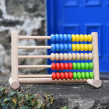 Bajo 50 bead wide abacus placed on a stone wall.