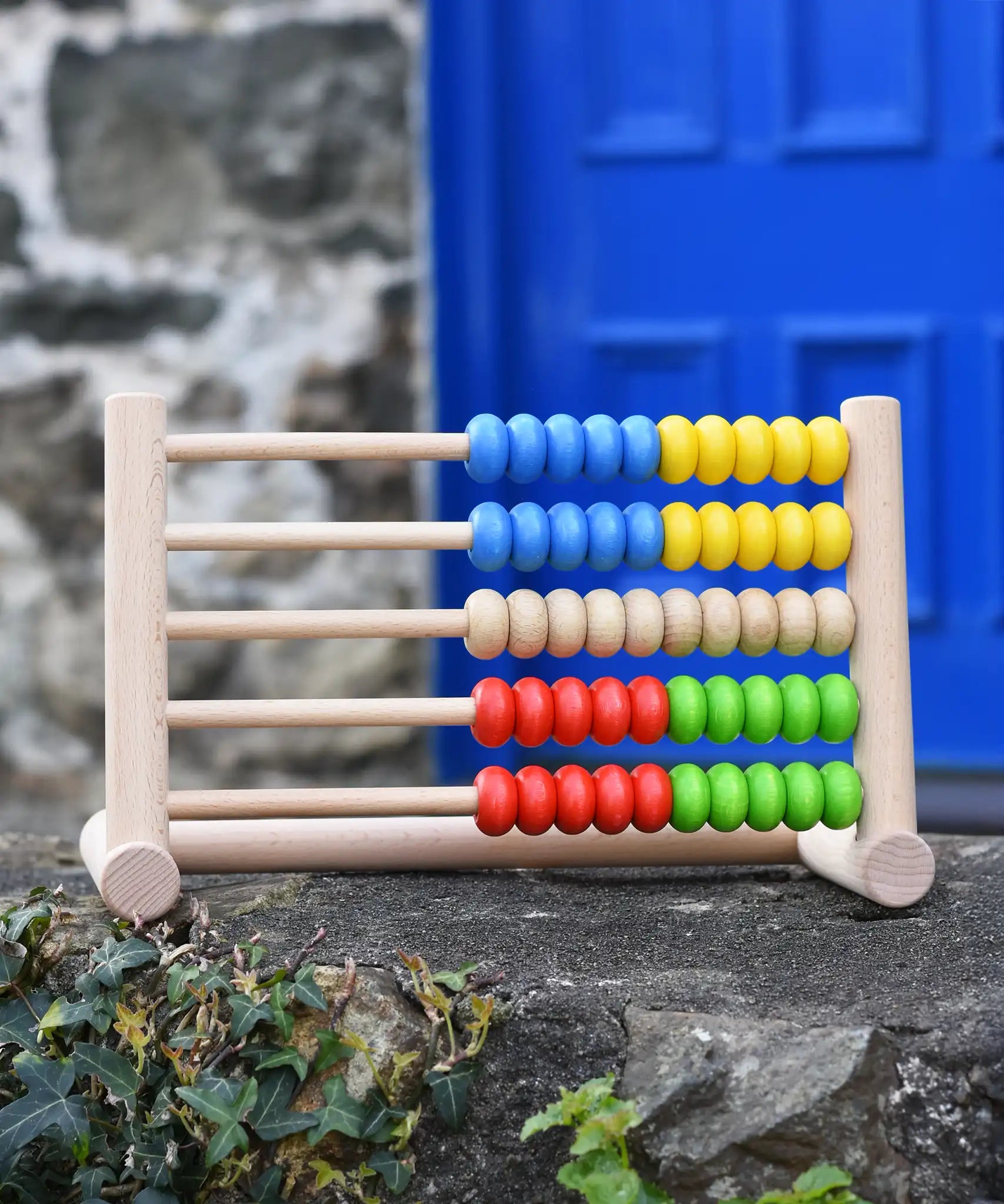 Bajo 50 bead wide abacus placed on a stone wall.