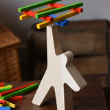 Bajo athlete wooden stacking balance game with wooden sticks balanced on the athlete shaped wooden figure base.