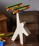 Bajo athlete wooden stacking balance game with wooden sticks balanced on the athlete shaped wooden figure base.