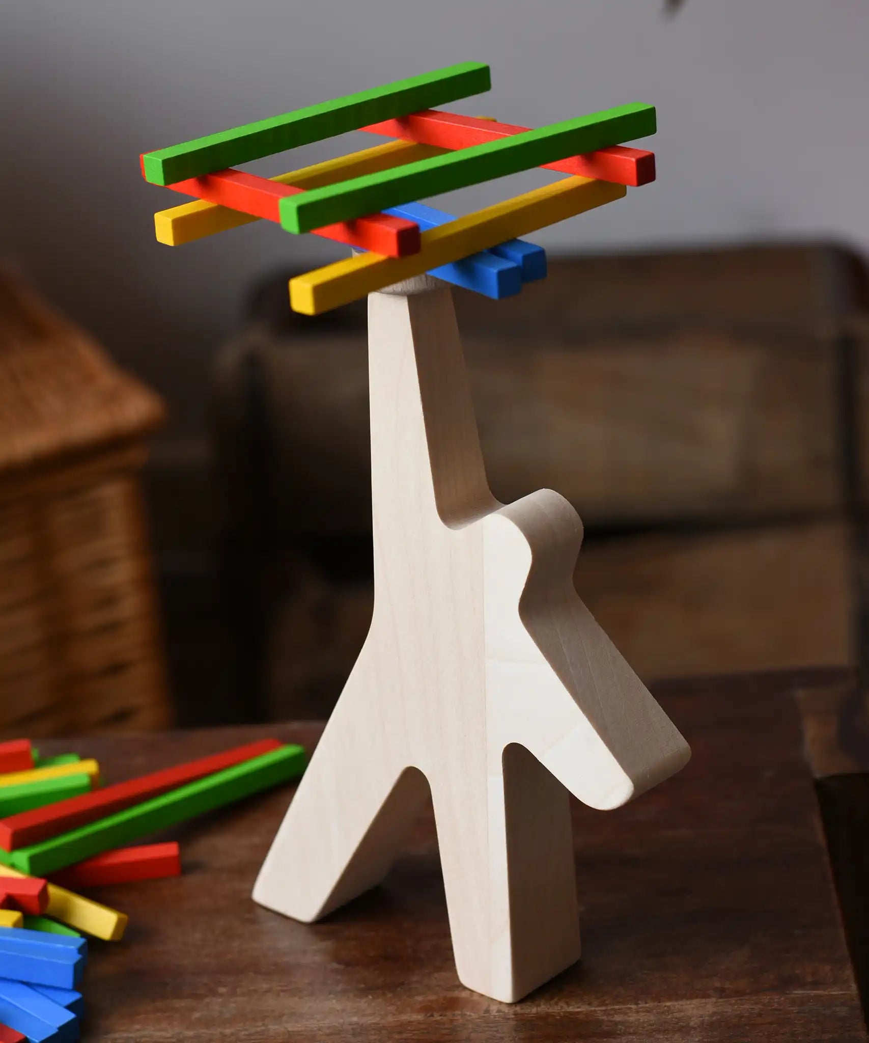 Bajo athlete wooden stacking balance game with wooden sticks balanced on the athlete shaped wooden figure base.