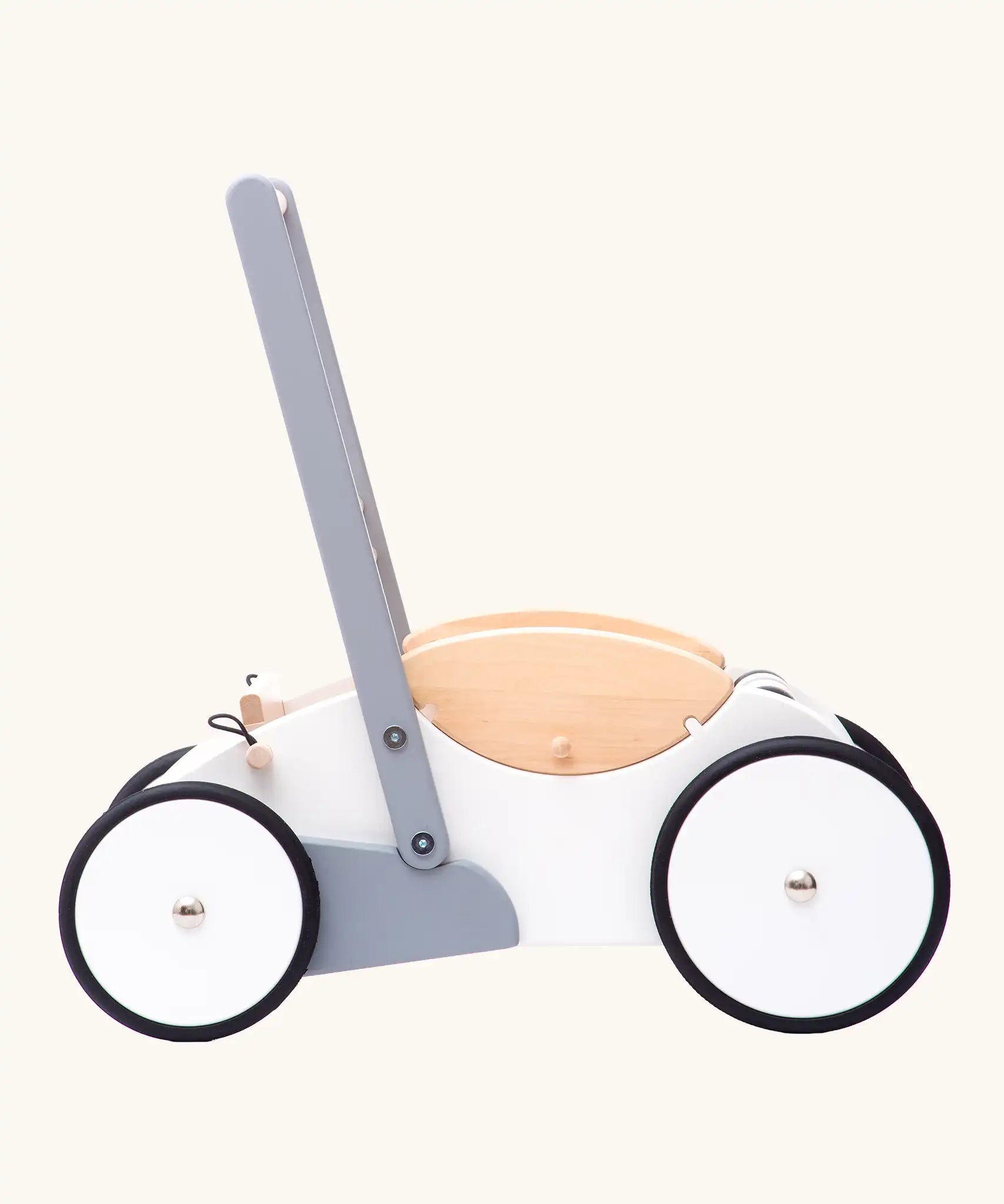 Side profile view of the Bajo wooden monochrome baby walker. Large white wheels with black rubber trims on the edges.
