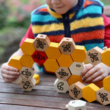 A child playing with the Bajo bee hive blocks.