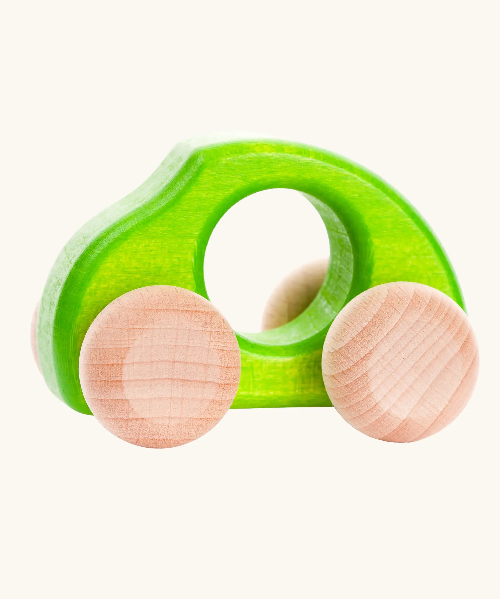 Bajo Beetle toy car in Green, a bright lime green wooden push-along toy for toddlers with a circular hand hole and natural wood wheels, available online from Babipur.